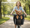 Small dog leaning out of the padded Goodsible pet bike basket during a park ride